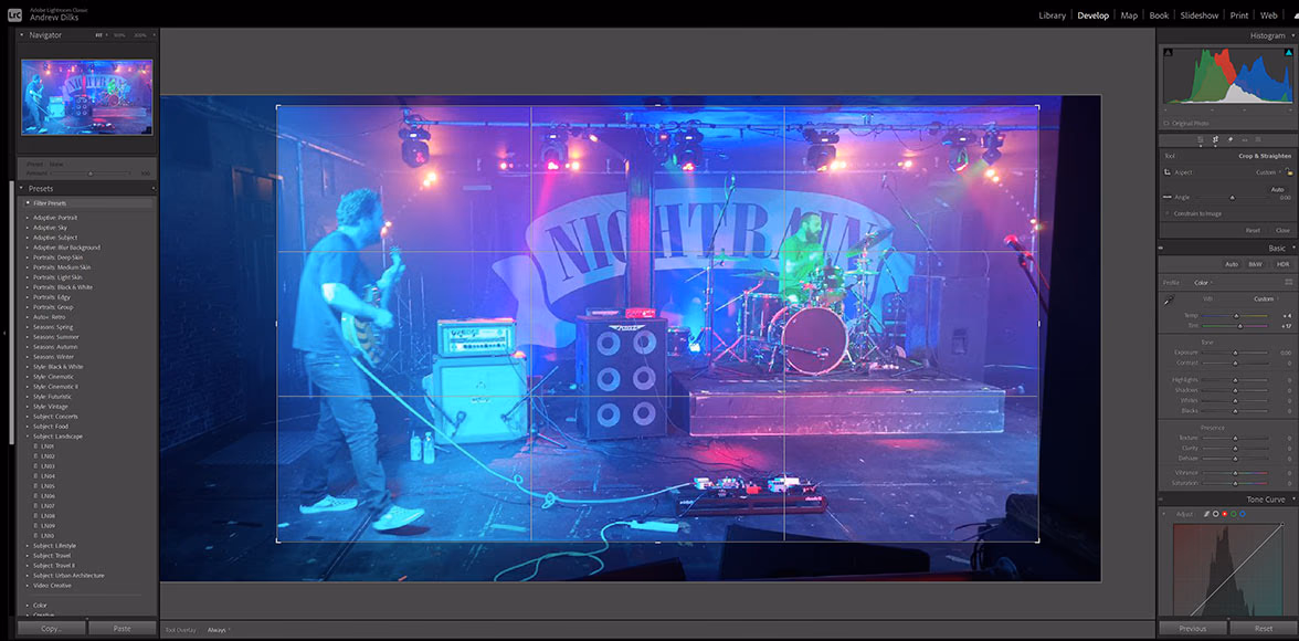 A photographer adjusting the crop on a concert photo in post